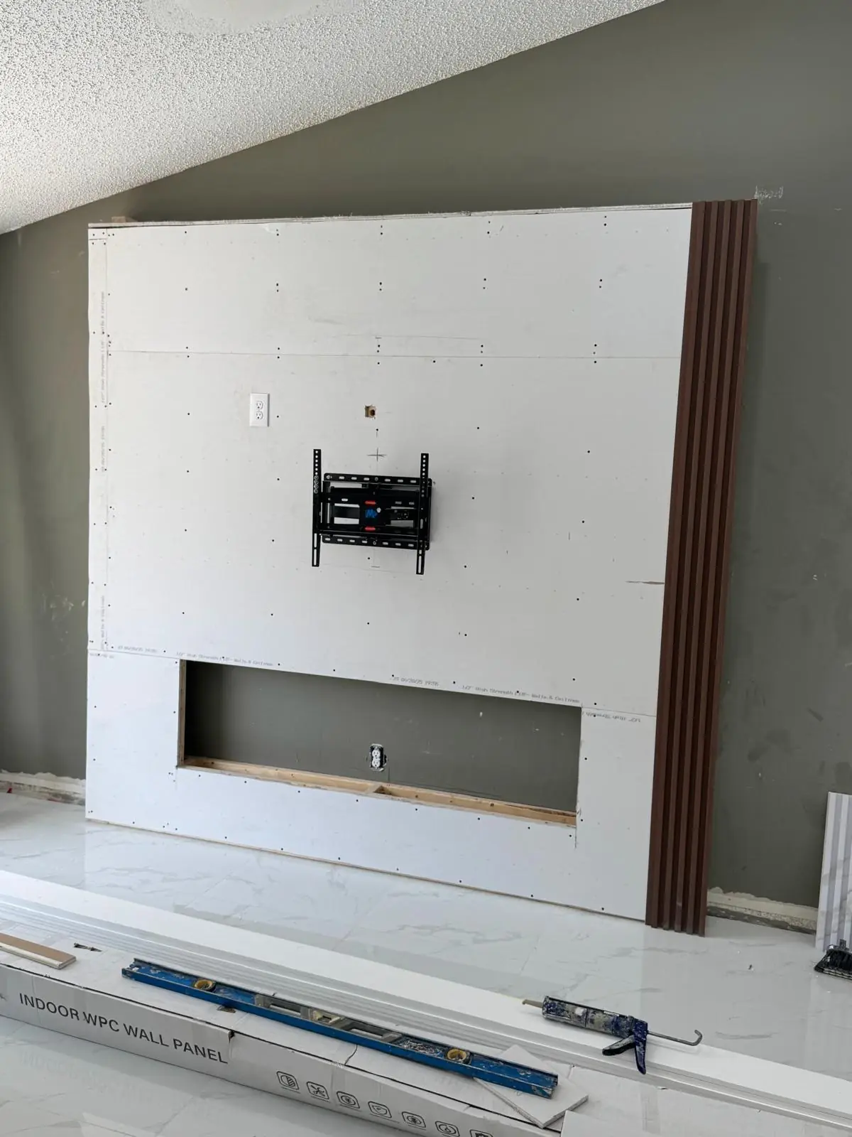A feature wall with a recessed area and paneling, ready for finishing touches.